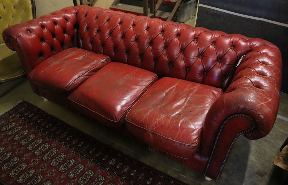 A buttoned red leather Chesterfield settee, width 194cm, depth 82cm, height 72cm